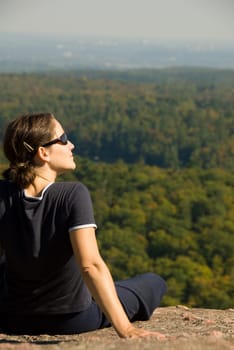 sitting woman on top of a mountain