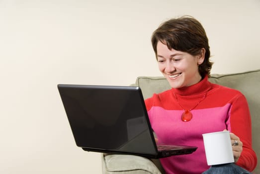 woman in livingroom on couch on laptop