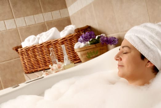 woman getting a spa bath to relax with bubbles