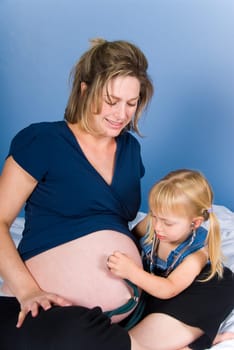 Cute blond girl with her happy mother