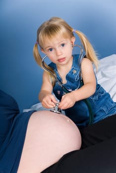 cute blond boy listening to the unborn child