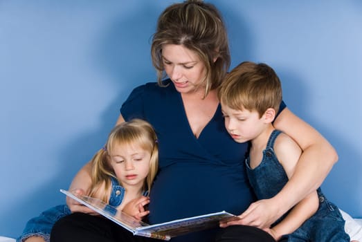 mother and her kids reading a book