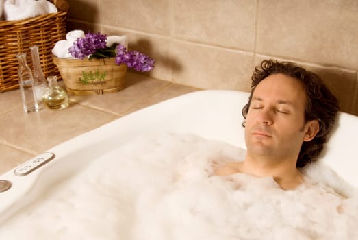 man client getting a bubble bath at spa