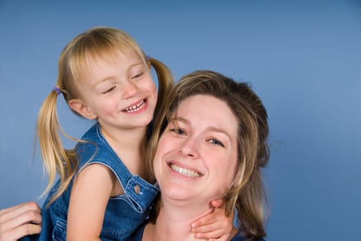 Cute blond girl with her happy mother