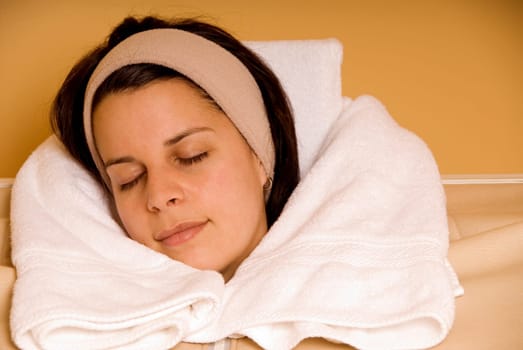 young woman relaxing in a steam sauna