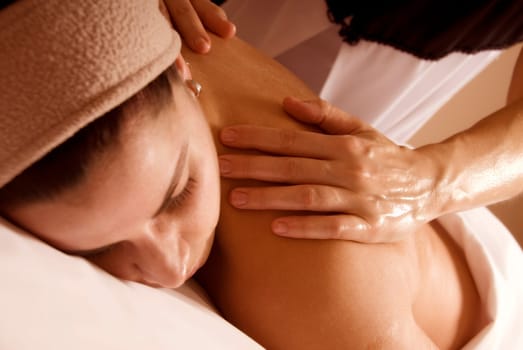 cute woman getting a massage treatment in a spa