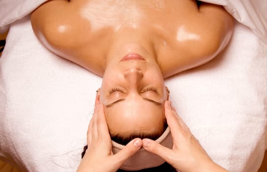 cute girl getting a face massage at a spa