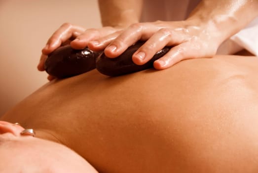 woman in a day spa getting a stone treatment