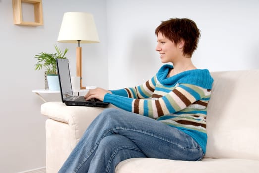 cute woman on her laptop on the couch
