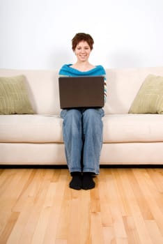 cute girl on her laptop on the couch