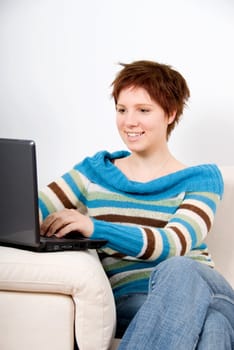 cute woman on the couch with her laptop