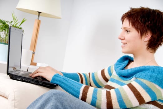 cute girl on her laptop on the couch