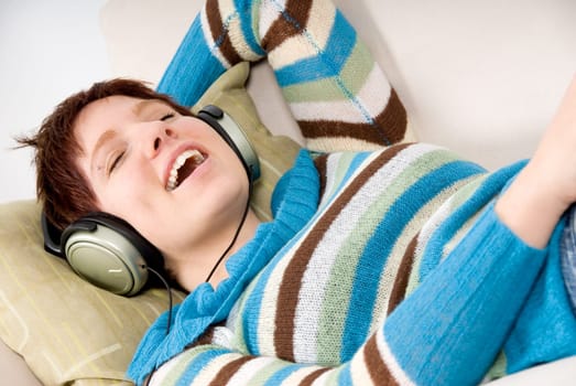 beautiful woman on her couch with the headphones