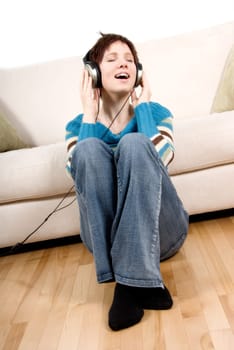 cute girl with headphone happy lying on the couch