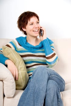 cute girl on the cell phone on couch