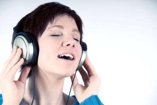 female happy is listening to music with headphones