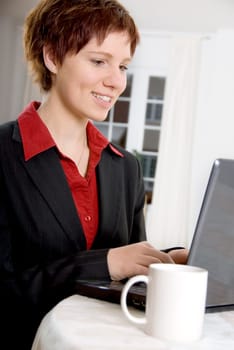 woman at home on her grey laptop