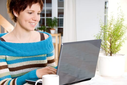 girl happy working with her laptop on the table