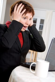 woman on laptop getting a bad surprise