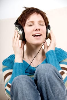 girl in casual dress listening to mp3 music