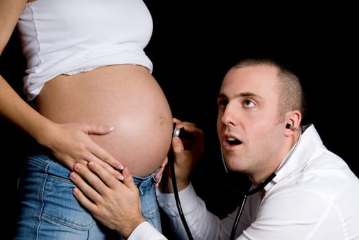 future father listening to the baby's heart beat