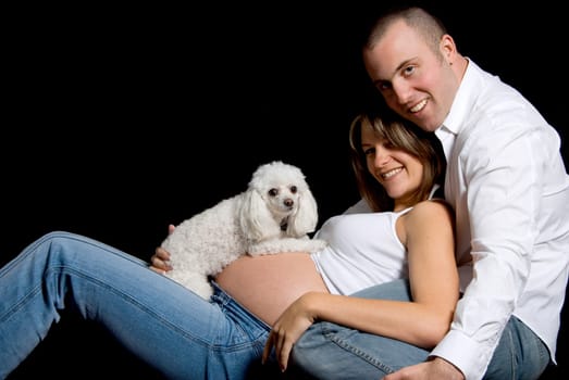 happy couple with their dog poodle lying down