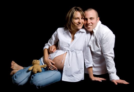 man and woman pregnant sitting on black