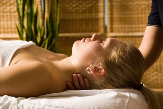 woman in a day spa getting a neck massage