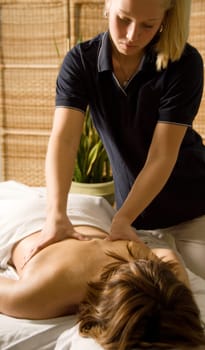 woman in a day spa getting a back massage
