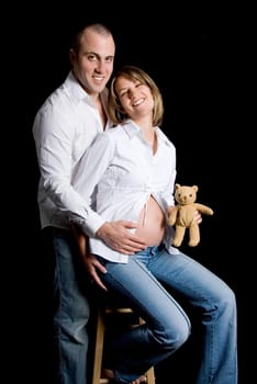 happy smiling couple with a toy teady bear