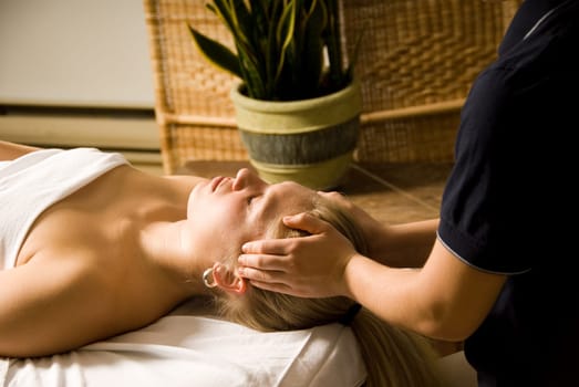woman in a day spa getting a massage by therapist
