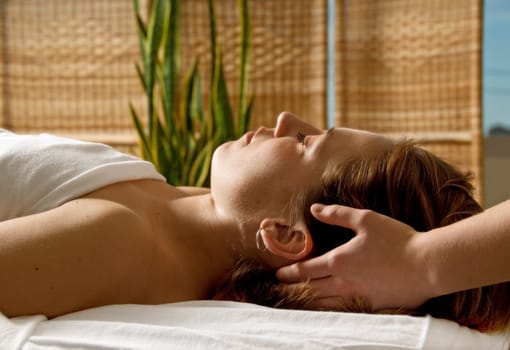 woman in a day spa getting a head massage