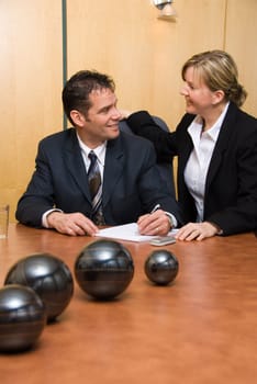 man and woman in a room with a paper pad writing