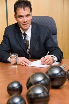 businessman in a room writing on paper