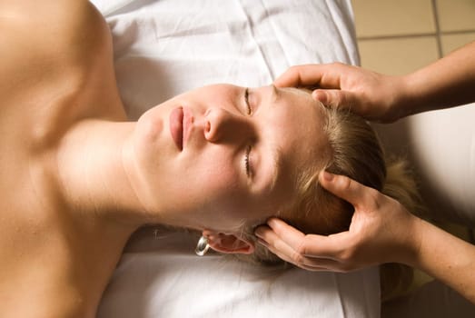 cute woman getting a massage at the head