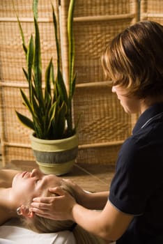 woman in a day spa getting a massage by therapist