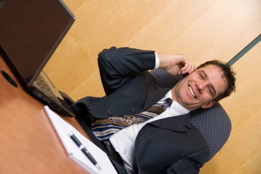 Businessman in a board room on the cell phone
