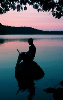 sitting on a rock on a lake