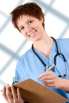 female happy doctor in blue scrubs with notepad