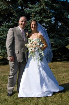 the married couple outside in the grass