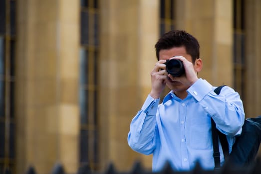 a tourist taking a photo with building