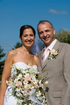 a just married man and woman by a lake