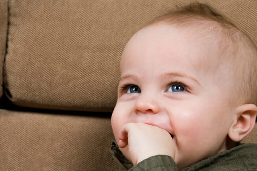 happy baby looking at his mom on sofa