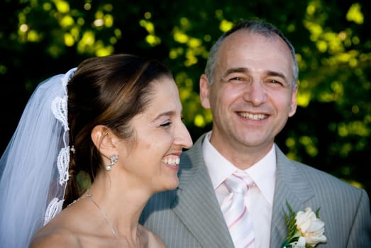 a just married man and woman by some trees