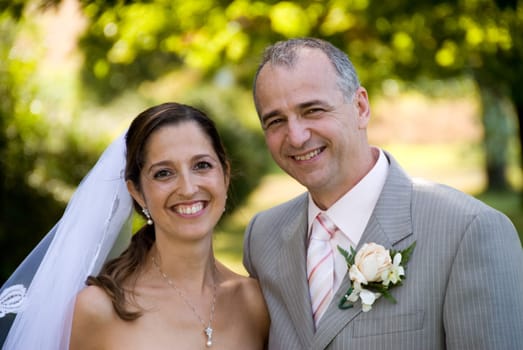 a just married man and woman by some trees