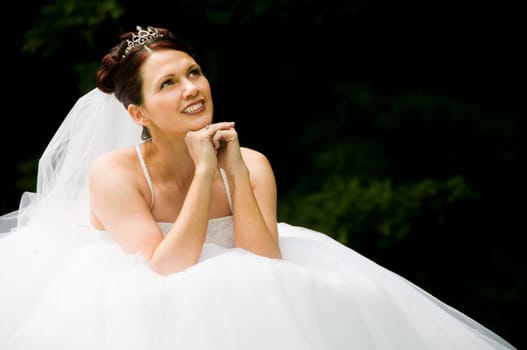 White Bride at her wedding posing with veil