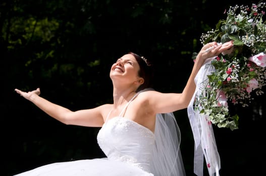 White Bride at her wedding posing with veil