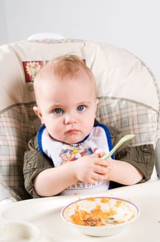 parent feeding a cute baby healthy food