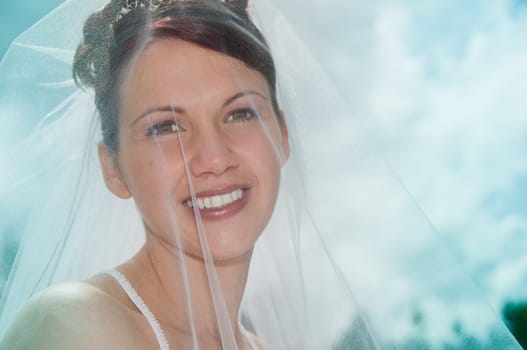 White Bride at her wedding posing with veil