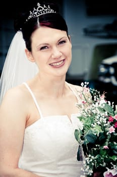 White Bride at her wedding posing with veil